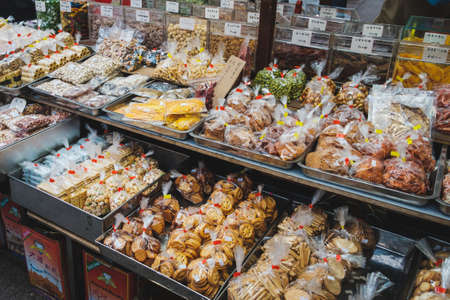 Hong Kong - November, 2019: Biscuits, nuts and snacks for sale on street food market in Hong Kongのeditorial素材