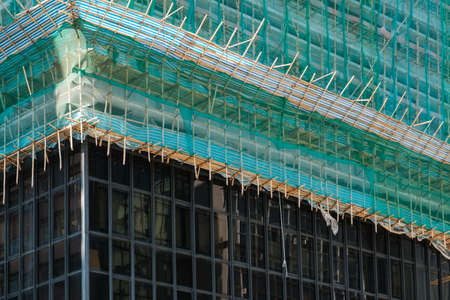 Bamboo pole scaffolding on building construction site -