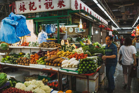 Hong Kong - November, 2019: Market stand selling vegetables  inside street food market centre in Hong Kongのeditorial素材