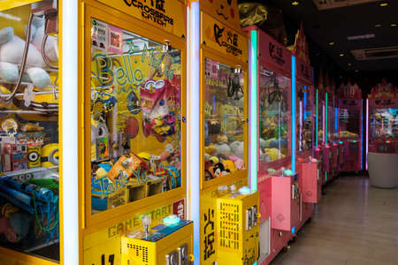 Hong Kong - November, 2019: Slot machine or automat with crane to grab and win  toys