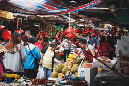 HongKong, China - November, 2019: People buying vegetables and fruits on street food market in HongKongのeditorial素材