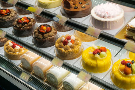 sweets and cakes on display in bakery shopの写真素材