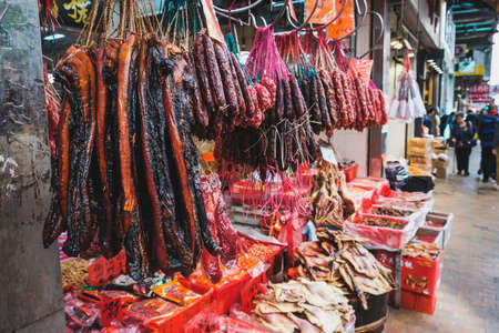 HongKong, China - November, 2019: Sausage and meat hanging in traditional butchery street market  in Hong Kongのeditorial素材