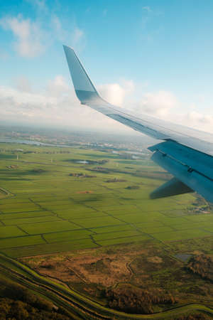 aiplane window view with ariplane wing and landscape aerial