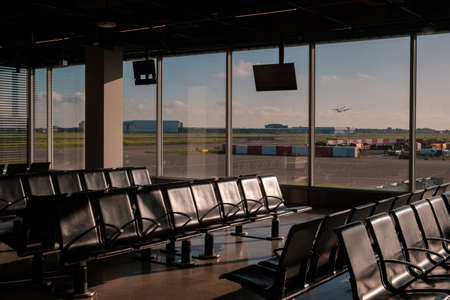 empty airport lounge with runway view windows -の写真素材