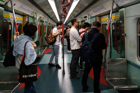 HongKong, China - November, 2019: People travel inside metro / MTR subway train in Hong Kongのeditorial素材