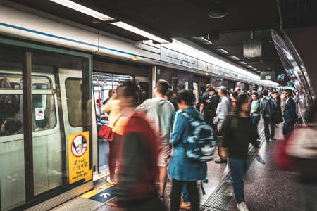 HongKong, China - November, 2019: People using subway train at MTR station / metro train station in...
