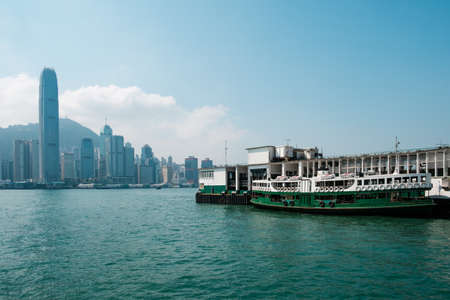 Hong Kong, China - November, 2019: Star Ferry boat on Tsim Sha Tsui Star Ferry Pier and HongKong Island skyline backgroundのeditorial素材