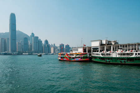 Hong Kong, China - November, 2019: Star Ferry boat on Tsim Sha Tsui Star Ferry Pier and HongKong Island skyline backgroundのeditorial素材