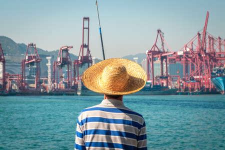 Fisherman looking at harbour in HongKong.