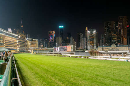 Hong Kong, November, 2019: Empty race track and skyline background, Horse racing course in Hong Kong Jockey Club, Happy Valleyのeditorial素材