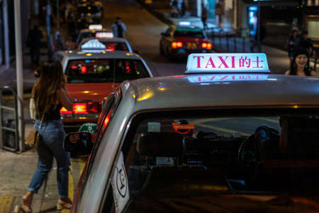 Hong Kong, November, 2019: Taxi cab car in Hong Kong at nightのeditorial素材