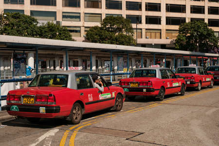 Hong Kong, November, 2019: Row of taxi cab cars waiting in Hong Kong