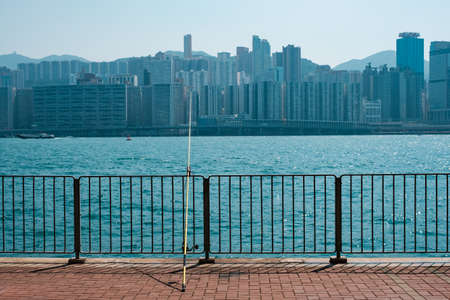 fishing rod on coast with skyline of Hong Kong, Kowloonの写真素材