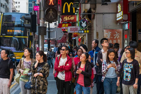 Hong Kong - November, 2019: Crowd of people waiting on traffic light to cross the street in Hong Kongのeditorial素材