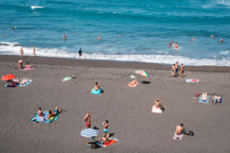 Tenerife, Spain - September, 2021: People at beach swimming in ocean in Puerto de la Cruz, Tenerife, Canary Islandsのeditorial素材