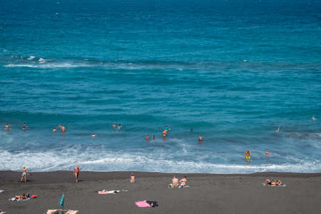 Tenerife, Spain - September, 2021: People at beach swimming in ocean in Puerto de la Cruz, Tenerife, Canary Islandsのeditorial素材