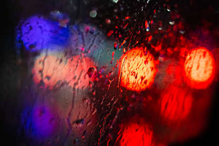 bokeh lights of cars behind window - traffic at night concept backgroundの写真素材