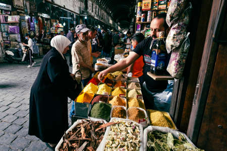 Damascus, Syria -May, 2022: Older couple buying food, herbals and spices at Suq Al Hamidiyah street market in Damascusのeditorial素材