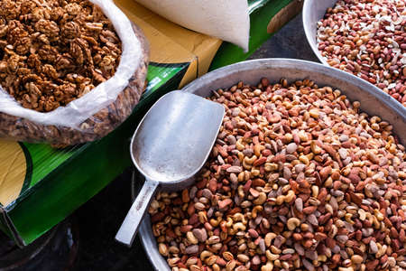 Mix of nuts on market, pile of peanuts, cashews, almonds and pistachioの写真素材