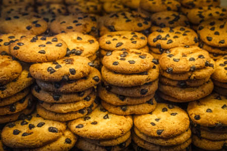 Pile of chocolate cookies in bakery displayの写真素材