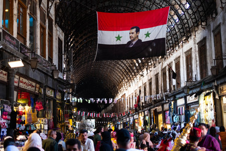 Damascus, Syria -May, 2022: Portrait image of Bashar al-Assad, President of Syria on syrian flag at Suq in Damascusのeditorial素材