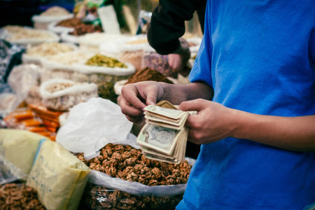 Vendor counting money on market, Syriaの写真素材