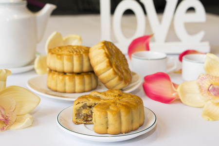 Moon cake, food for Vietnamese mid autumn festival. Focus on moon cake and others are blurredの写真素材