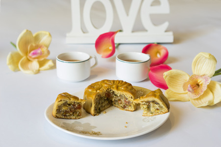 Moon cake, food for Vietnamese mid autumn festival. Focus on moon cake and others are blurredの写真素材