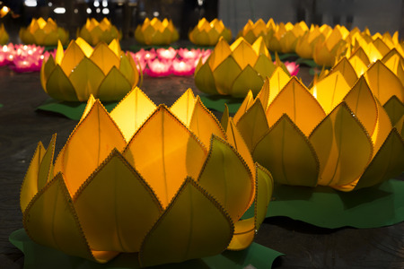 Flower garlands and colored lanterns for celebrating Buddha's birthday in Eastern culture. They are made from cut paper and candleの写真素材