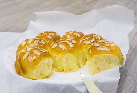 Homemade sweet bun with almond and dried grape