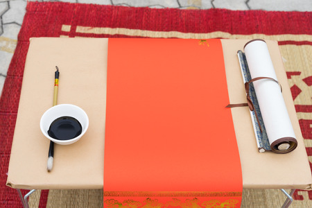 Calligraphy instruments with red paper, black ink, brush...Calligraphy is oriental culture in Lunar...