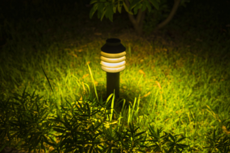Small Garden Lamp on surrounded grass fieldの写真素材