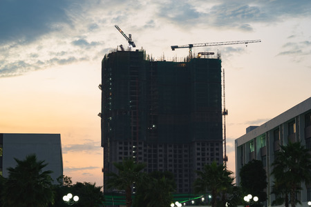 Silhouette of construction site at sunset