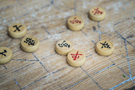 Chinese chess pieces made of wood on chessboardの写真素材