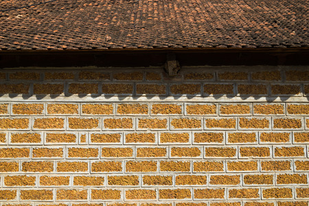 Laterite wall with tiled roofの写真素材