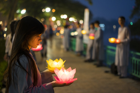 Hanoi, Vietnam - Oct 10, 2014: Buddhists hold flower garlands and colored lanterns for celebrating Buddha's birthday organised at Tran Quoc templeのeditorial素材