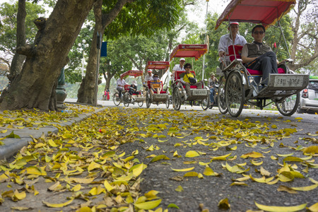 Hanoi, Vietnam - April 13, 2014: Traffic on street in falling season in Hanoi, Vietnam with a lot of...