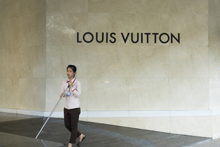 Hanoi, Vietnam - Sept 14, 2014: Unidentified worker cleans floor of Trang Tien plaza on Hang Bai...