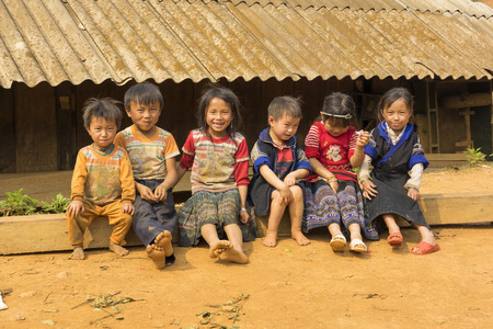 Yen Bai, Vietnam - Apr 12, 2014: Unidentified Hmong children playing on playground in front of there houses under sunlight. The Hmong are an Asian ethnic group from the mountainous regionsのeditorial素材