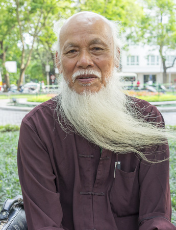 Hanoi, Vietnam - May 3, 2014: Portrait of an old man with long white beard sitting on park in Hanoi, Vietnamのeditorial素材
