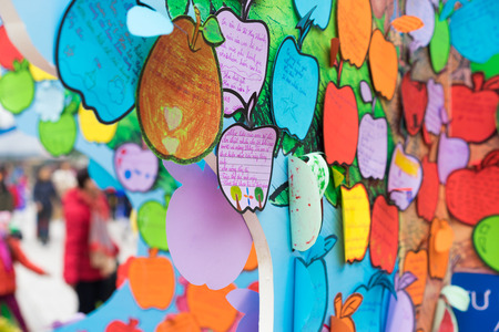 Hanoi, Vietnam - Feb 7, 2015: Children's promises writen on papers hanging on tree at Vietnamese lunar new year festival organized at Vinschool, Vinhomes Times City, Minh Khaiのeditorial素材