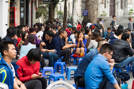 Hanoi, Vietnam - Mar 15, 2015: Tea stall on Hoan Kiem street - the shortest street in Hanoi. People...