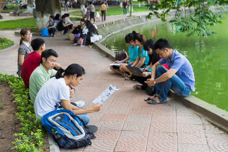 Hanoi, Vietnam - Apr 5, 2015: Group of students learn English at Hoan Kiem lake, center of Hanoiのeditorial素材
