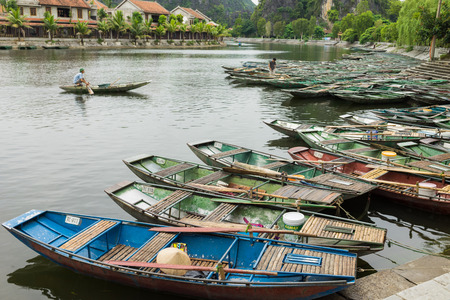 Ninh Binh, Vietnam - May 16, 2015: Tourism boats stay next to each others waiting for tourist at Tam Coc, the popular travel destination in Vietnamのeditorial素材
