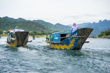 Quang Binh, Vietnam - June 16, 2016: Semi power/rowing tourism boat on river to Phong Nha cave, Phong Nha - Ke Bang national park, Quang Binh, Vietnamのeditorial素材