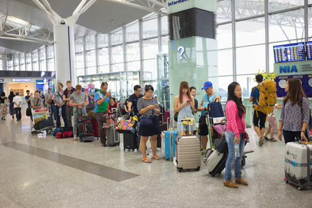 Hanoi, Vietnam - Apr 29, 2016: Queue of Asian people in line waiting at boarding gate in Noi Bai...