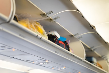 opened luggage cabin on airplaneの写真素材