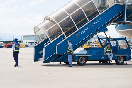 Khanh Hoa, Vietnam - July 30, 2016: Vietnam Airlines stairs ready for passenger to step down, with aviation service staffs in Cam Ranh international airportのeditorial素材