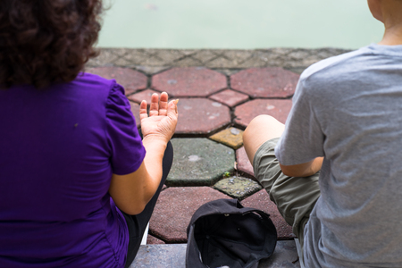 Old couple meditating outdoor closeupの写真素材